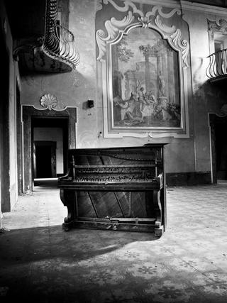 Illustration for article titled Photos of an abandoned asylum shot in black and white, complete with creepy mural